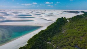 Len&ccedil;&oacute;is Maranhenses: aerial view of a sandy beach surrounded by trees