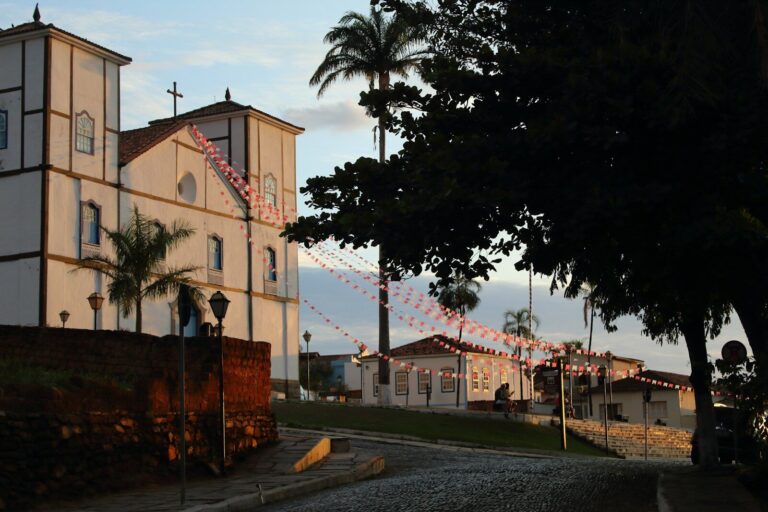 Church building with palm trees and decorations at sunset