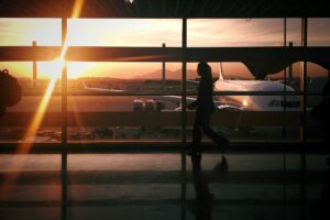 Brazil tourism statistics 2026: Traveler walking through a Brazilian airport terminal at sunset, symbolizing the record growth in international tourist arrivals to Brazil