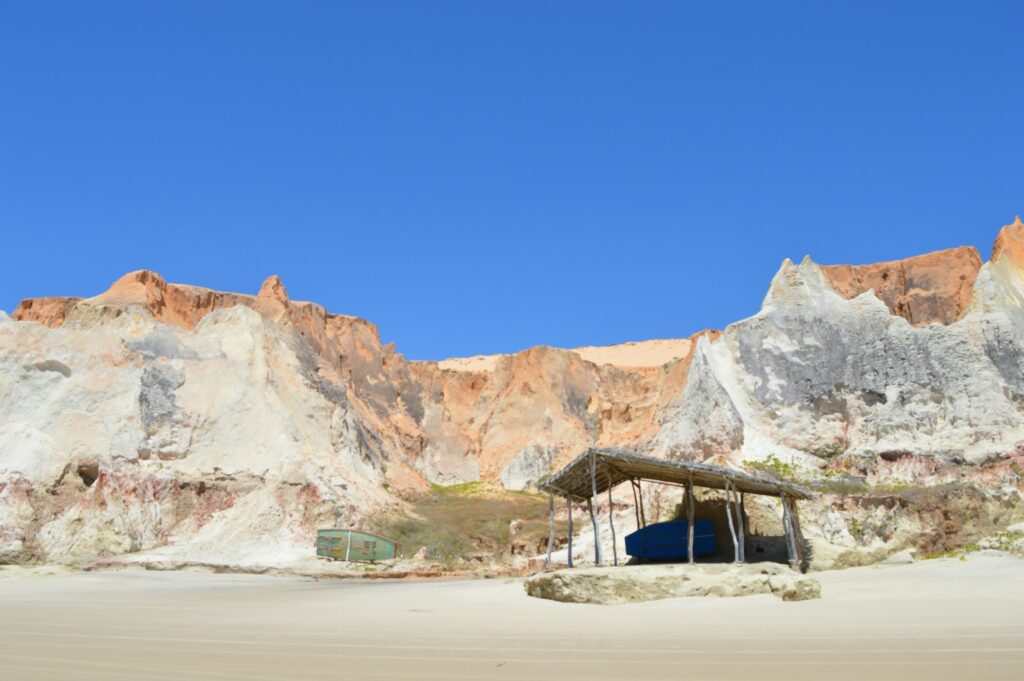 A fishing boat below the cliffs of Canoa Quebrada, by Nestor Roco