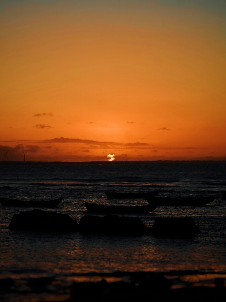 Sunset over boats at Pedra do Sal beach, Parnaíba, Piauí, by Eduardo Vilar