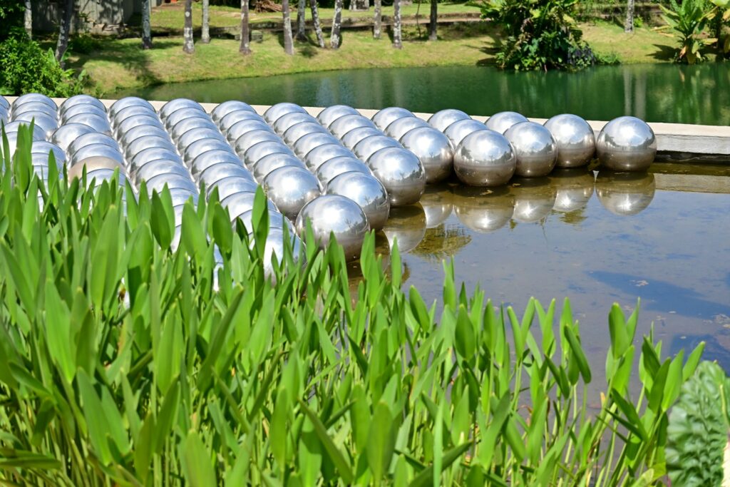 Yayoi Kusama's Narcissus Garden of steel spheres floating on the water at Inhotim, by Fernando Dantas