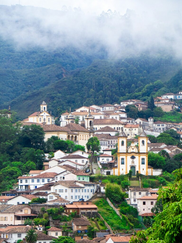 Aerial view of colonial houses on the hills of Ouro Preto, by Tchelo Veiga