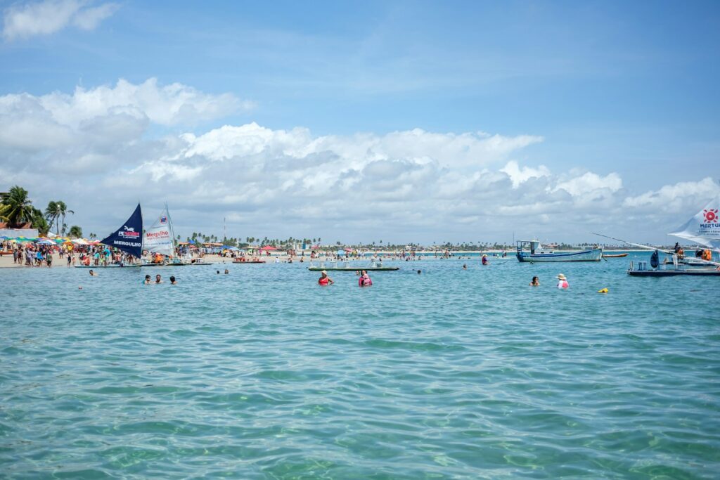 Swimmers in the clear water off Porto de Galinhas, by Mayumi Maciel