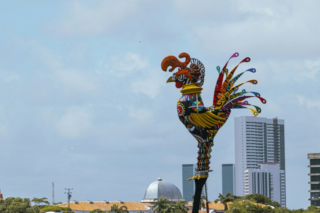 The giant carnival rooster of the Galo da Madrugada against the Recife skyline, by Thiago Japyassu