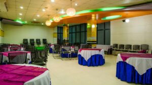 Banquet tables set for a corporate event in a large hall